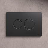 NATIVA Placca Bolla JP2NM nero opaco con pulsanti tondi su parete in cemento vista frontale